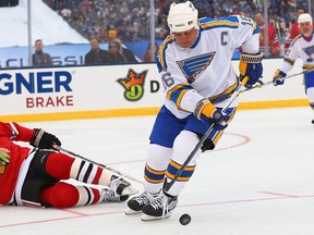 Jack O'Callahan of the Chicago Blackhawks defends against Brett Hull of the St. Louis Blues during the 2017 NHL Winter Classic Alumni Game at Busch Stadium on Dec. 31, 2016
