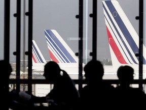 This file photo taken on September 15, 2014 at Orly airport, south of Paris, shows passengers in a waiting lounge as Air France planes are seen behind.