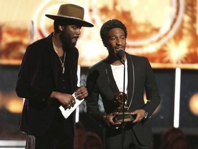Gary Clark Jr. , left, and Jon Batiste announce that the award for best pop solo performance is won by Ed Sheeran at the 60th annual Grammy Awards at Madison Square Garden on Sunday, Jan. 28, 2018, in New York.