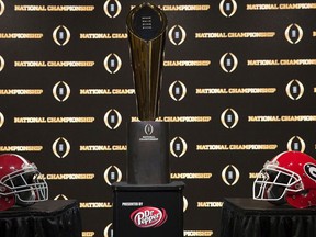 The College Football Playoff National Championship trophy, along with the helmets of the 2 competing teams, University of Alabama (left) and University of Georgia (right) on January 7, 2018 in Atlanta, Georgia.