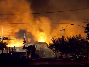 This file photo taken on July 5, 2013 shows firefighters as they douse blazes after a freight train loaded with oil derailed in Lac-Megantic, Que.  (FRANCOIS LAPLANTE-DELAGRAVE/AFP/Getty Images)