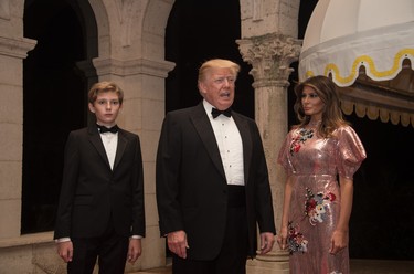 US President Donald Trump, First Lady Melania Trump and their son Barron arrive for a new year's party at Trump's Mar-a-Lago resort in Palm Beach, Florida, on December 31, 2017. / AFP PHOTO / Nicholas KammNICHOLAS KAMM/AFP/Getty Images