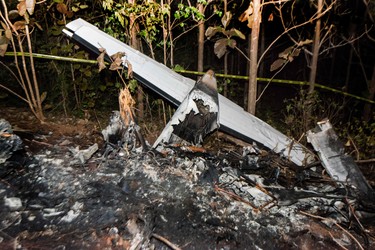 The tail of the burned fuselage of a small plane that crashed, rests near trees in Guanacaste, Corozalito, Costa Rica on Dec. 31, 2017. (EZEQUIEL BECERRA/AFP/Getty Images)