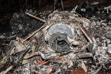 The remains of the burned fuselage of a small plane that crashed are seen in Guanacaste, Corozalito, Costa Rica on Dec. 31, 2017. (EZEQUIEL BECERRA/AFP/Getty Images)