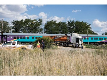 Emergency service workers stand near the site of where a train crashed into truck on January 4, 2018, in Kroonstad, Free State Province.