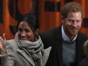 This file photo taken on January 09, 2018 shows Britain's Prince Harry and his fiancée US actress Meghan Markle arriving for their visit to Reprezent 107.3FM community radio station in Brixton, south west London on January 9, 2018.