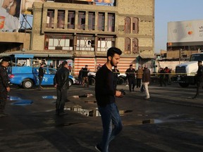 Iraqi security forces cordon off the area where a double suicide bombing killed more than 20 people in central Baghdad on January 15, 2018.