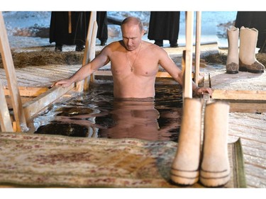 Russian President Vladimir Putin plunges into the icy waters of lake Seliger during the celebration of the Epiphany holiday in Russia's Tver region early on January 19, 2018.