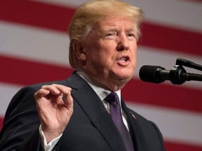 (FILES) This file photo taken on December 18, 2017 shows US President Donald Trump speaking about his administration's National Security Strategy at the Ronald Reagan Building and International Trade Center in Washington, DC. President Donald Trump launched a fresh attack on his opponents ahead of a new effort in the bitterly divided US Congress to end a budget impasse before hundreds of thousands of federal workers are forced to start the workweek at home without pay. The impact of the shutdown that began at midnight on January 19, 2018 has been largely limited so far, closing sites like New York's Statue of Liberty, but the effect will start to become acute if the stalemate runs into the start of the following week.
