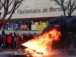 Striking prison guards demonstrate in front of Nice prison on January 22, 2018 in Nice, southeastern France as part of a nationwide movement to call for for better safety and wages. BORIS HORVAT/AFP/Getty Images