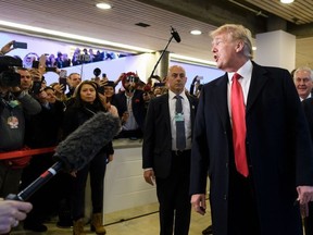 US President Donald Trump arrives next to Founder and Executive Chairman of the World Economic Forum (WEF) Klaus Schwab (R) to address the World Economic Forum (WEF) annual meeting on January 26, 2018 in Davos, eastern Switzerland.