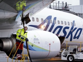 In this Nov. 14, 2016, photo, fueling manager Jarid Svraka looks on as he fuels an Alaska Airlines Boeing 737-800 jet with a new jet fuel, at Seattle-Tacoma International Airport in SeaTac, Wash.