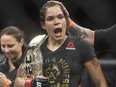 Amanda Nunes of Brazil celebrates after defeating Valentina Shevchenko of Kyrgyzstan during their mixed martial arts bout at UFC 215 in Edmonton on Sept. 9, 2017.