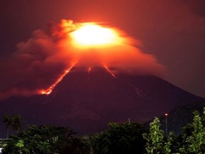 Lava cascades down the slopes of Mayon volcano as seen from Legazpi city, Albay province, around 340 kilometers (210 miles) southeast of Manila, Philippines, Monday, Jan. 15, 2018. More than 9,000 people have evacuated the area around the Philippines' most active volcano as lava flowed down its crater Monday in a gentle eruption that scientists warned could turn explosive.