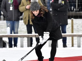 Britain's Kate, Duchess of Cambridge tries a shot with a bandy stick in Stockholm, Sweden, Tuesday Jan. 30, 2018, during Prince William and Duchess of Cambridge 4-day visit to Sweden and Norway.