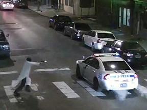 In this Jan. 7, 2016, image made from a video provided by the Philadelphia Police Department, a gunman runs toward a police car driven by Philadelphia police officer Jesse Hartnett in Philadelphia. (Philadelphia Police Department via AP, File)