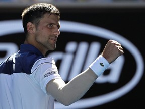 Serbia's Novak Djokovic celebrates after defeating United States' Donald Young during their first round match at the Australian Open tennis championships in Melbourne, Australia, Tuesday, Jan. 16, 2018.