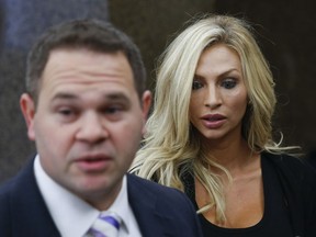 Lindy Lou Layman, right, stands with her defense attorney Justin Keiter after making an appearance in court, Tuesday, Jan. 9, 2018, in Houston. Layman is challenging allegations that she caused at least $300,000 in damage to a prominent Houston attorney's art collection at the end of their first date. She is charged with felony criminal mischief for the Dec. 23 incident in the home of attorney Tony Buzbee.