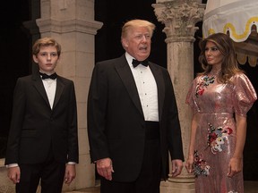 U.S. President Donald Trump, first lady Melania Trump and their son Barron arrive for a new year's party at Trump's Mar-a-Lago resort in Palm Beach, Florida, on Dec. 31, 2017. (NICHOLAS KAMM/AFP/Getty Images)
