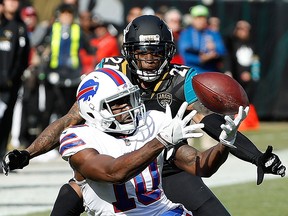 Deonte Thompson of the Buffalo Bills and A.J. Bouye of the Jacksonville Jaguars battle for the football at EverBank Field on January 7, 2018 in Jacksonville.