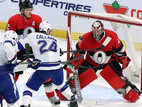 Ottawa Senators goaltender Craig Anderson (41) reacts to a flying puck as defenceman Dion Phaneuf (2) and Tampa Bay Lightning right wing Ryan Callahan (24) look on in Ottawa, Saturday, January 6, 2018.