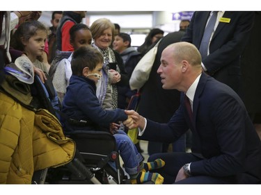Britain's Prince William meets patients as he visits the Evelina London Children's Hospital, in London on Thursday, Jan. 18, 2018, to launch a nationwide programme to help veterans find work in the NHS.