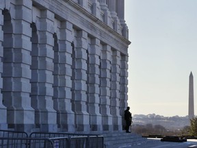 As a bitterly-divided Congress hurtles toward a government shutdown this weekend, a Capitol Police officer guards his post, Friday, Jan. 19, 2018, on Capitol Hill in Washington. (AP Photo/Jacquelyn Martin)