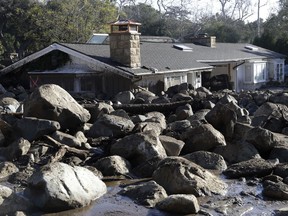 Large rocks and mud are shown in front of a house in Montecito, Calif., Thursday, Jan. 11, 2018.