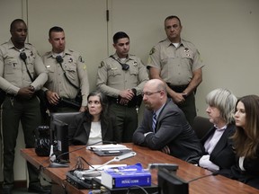 In this Jan. 18, 2018, file photo, defendants Louise Anna Turpin, left, with attorney Jeff Moore, and David Allen Turpin, right, with attorney Allison Lowe, appear in court for their arraignment in Riverside, Calif.