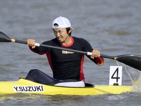 In this November 2010, photo, Japan's Yasuhiro Suzuki competes in the mens single kayak race at the 16th Asian Games in Shanwei, China.