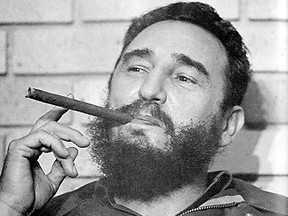 A young Fidel Castro enjoying a cigar.
