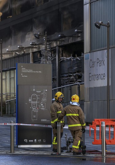Emergency services attend the scene after a fire at a multi-storey car park on Liverpool's waterfront, north west England, Monday Jan. 1, 2018.   (Peter Byrne/PA via AP)