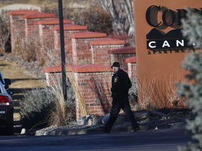 An investigator heads to the scene of a shooting in Highlands Ranch, Colo., Sunday, Dec. 31, 2017.  One deputy died and multiple others were wounded, along with two civilians, in a shooting that followed a domestic disturbance in suburban Denver.