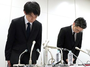 In this Friday, Jan. 26, 2018, photo, Coincheck President Koichiro Wada, left, bows in apology at the beginning of a news conference in Tokyo. (Takuya Inaba/Kyodo News via AP)