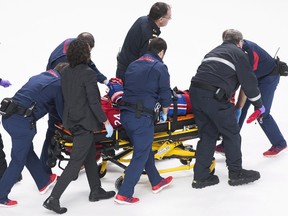 Montreal Canadiens' Phillip Danault is stretchered off the ice after he was hit in the head by a shot from Boston Bruins' Zdeno Chara in Montreal, Saturday, January 13, 2018.