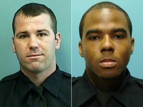 This undated file photo provided by the Baltimore Police Department shows Detective Marcus Taylor (right) and Detective Daniel Hersl.