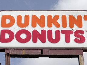 This Thursday, Aug. 3, 2017 file photo shows a Dunkin' Donuts sign at a store in Hialeah, Fla. A new Dunkin' Donuts store being unveiled in the Boston suburb of Quincy on Tuesday, Jan. 16, 2018, will be the first in the nation to be billed simply as "Dunkin." (AP Photo/Alan Diaz)