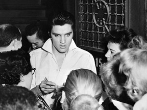 Elvis Presley (C) is surrounded by fans after a concert, in 1958. (AFP/Getty Images)