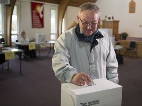 Former Premier Darrell Dexter votes in the Nova Scotia provincial election in Cole Harbour, N.S., near Halifax on Tuesday, Oct. 8, 2013.