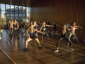 In this Aug. 16, 2017 photo, Nicole Winhoffer, front right, teaches her NWMethod fitness class at The Standard Hotel in New York. Loved by Madonna and Kate Hudson, Winhoffer mixes dance cardio and strength training. Her workout NW Church gives you access to the hour-long class Winhoffer teaches in New York every Sunday so you're sweating right alongside Nicole. (Gabriel Eugene/Nicole Winhoffer via AP) ORG XMIT: NYLS320