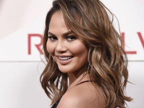 In this Nov. 2, 2017 file photo, model Chrissy Teigen poses at the 2017 Revolve Awards at the Dream Hollywood hotel in Los Angeles.