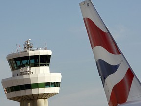 A tailfin of a British Airways jet pictured in front of the control tower at Gatwick airport is seen in a file photo. (ADRIAN DENNIS/AFP/Getty Images)