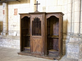 In this stock photo, a confession booth sits empty in a church.