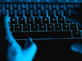 In this stock photo, a hacker types on an illuminated keyboard.