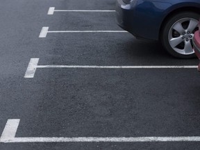 In this stock photo, two cars sit parked in a lot.