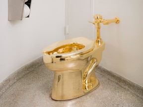 In this undated photo provided by the Solomon R. Guggenheim Museum, an 18-karat gold toilet is shown in the museum's 14th floor restroom in New York. (Kristopher McKay/Solomon R. Guggenheim Museum via AP)