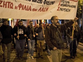 Demonstrators march against Turkey's President Recep Tayyip Erdogan's visit in Athens, Thursday, Dec. 7, 2017. (AP Photo/Petros Giannakouris)
