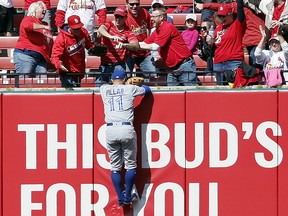 Toronto Blue Jays centre fielder Kevin Pillar climbs the outfield wall in an attempt to catch a home run hit by St. Louis Cardinals' Randal Grichuk Thursday, April 27, 2017, in St. Louis. (AP Photo/Jeff Roberson)
