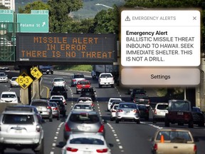 In this Jan. 13, 2018, file photo provided by Civil Beat, cars drive past a highway sign that says "MISSILE ALERT ERROR THERE IS NO THREAT" on the H-1 Freeway in Honolulu.