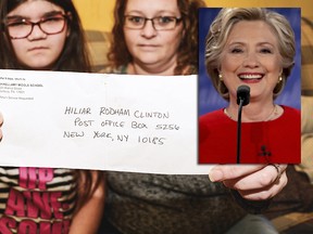 Mary Reinard, 11, and her step-mother Shannon Reinard, hold up a letter Tuesday, Jan. 30, 2018 that Mary had hoped to send to Hillary Clinton.  The Sunbury family called for a public apology on Tuesday from Shikellamy Middle School teacher Benjamin Attinger, who admits he intentionally misaddressed a letter their 11-year-old daughter had written to Hillary Clinton. (Robert Inglis/The Daily Item via AP)